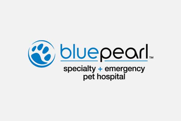 Logo for BluePearl Specialty + Emergency Pet Hospital. It features a blue paw print inside a circle to the left of the words "bluepearl" and "specialty + emergency animal hospital" in black and blue text on a white background.