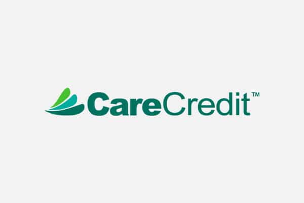 CareCredit logo with three green overlapping leaf shapes to the left of the words "CareCredit" in green and teal text, often seen at your local veterinarian or animal hospital, on a light gray background.